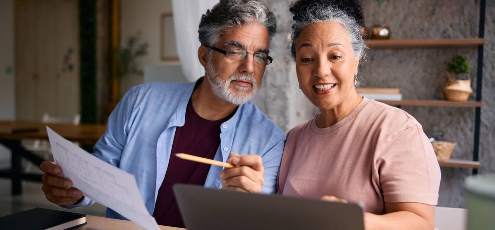 a couple working on a laptop computer