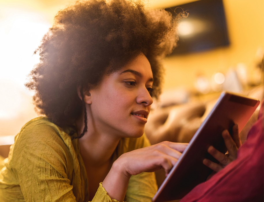 a woman looking at her tablet