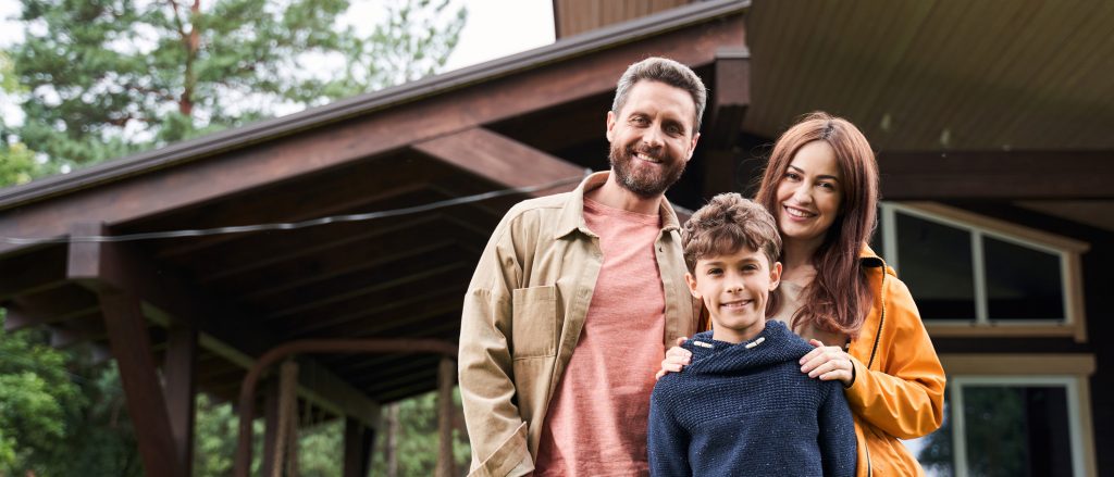 Happy family posing together outside the house